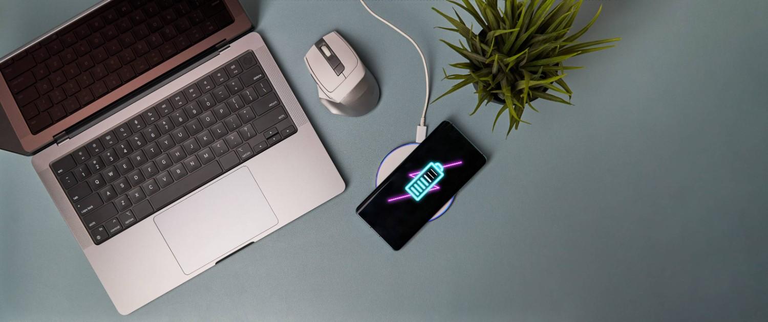 A Laptop Mouse And Phone With Wireless Charging