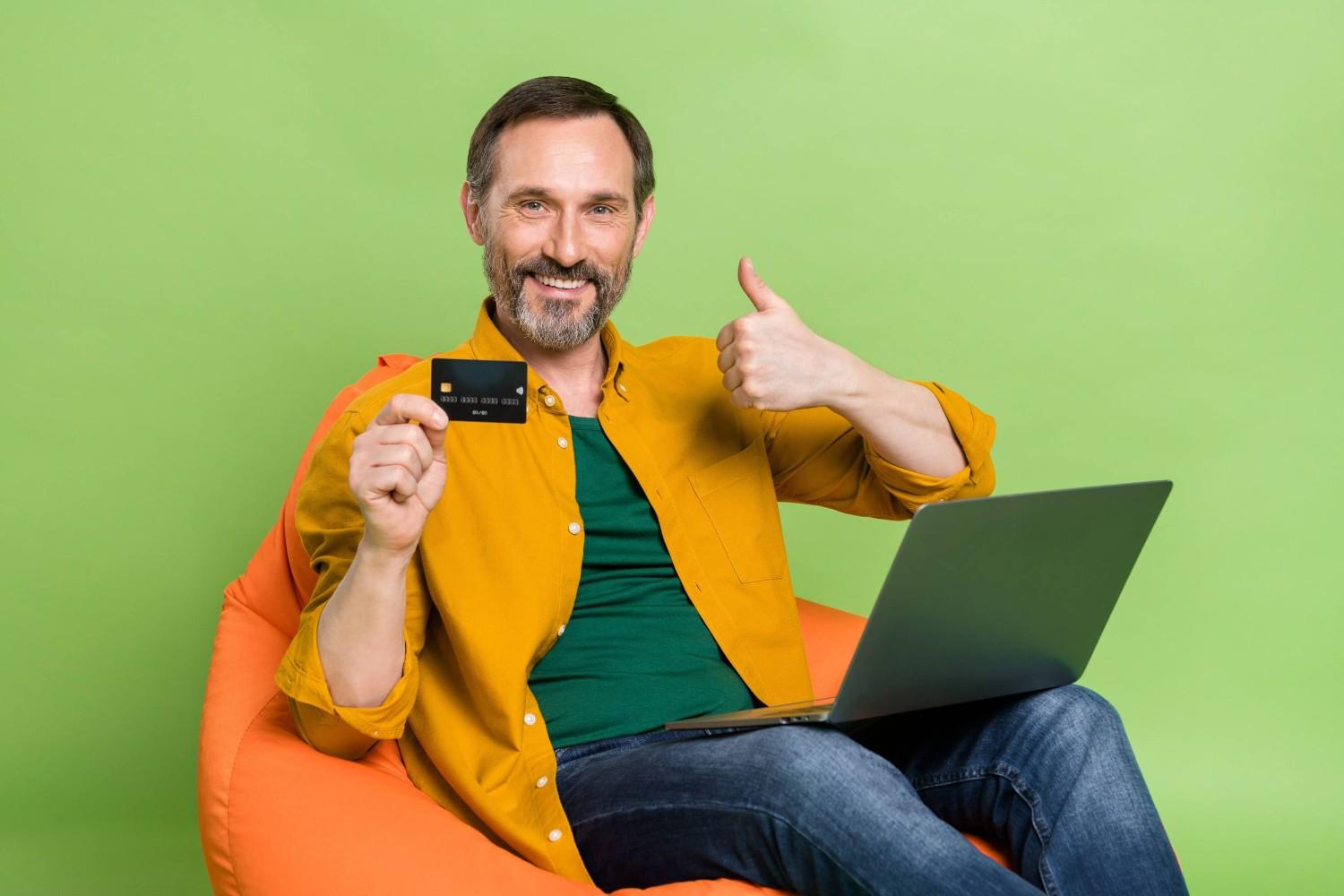 A Man Holding A Credit Card