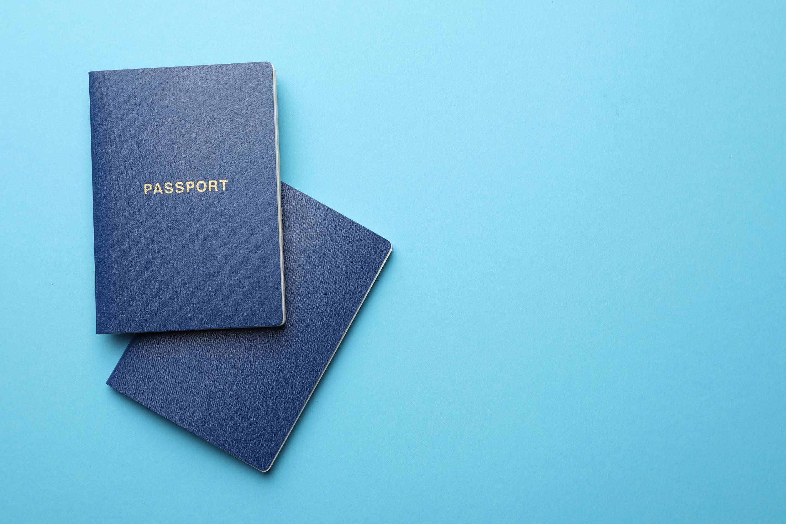 Passports On Plain Blue Background